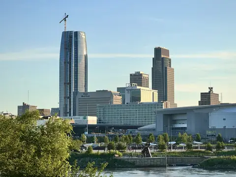 Downtown Omaha seen across the lagoon at Heartland of America Park on a clear summer day