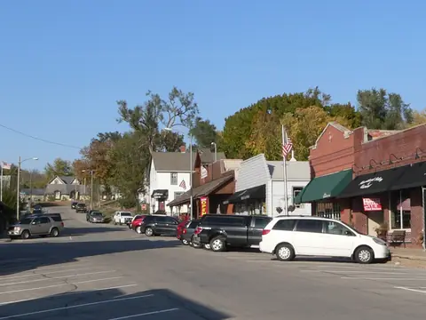 Brick storefronts along the main street of old downtown Elkhorn, Nebraska under a blue sky