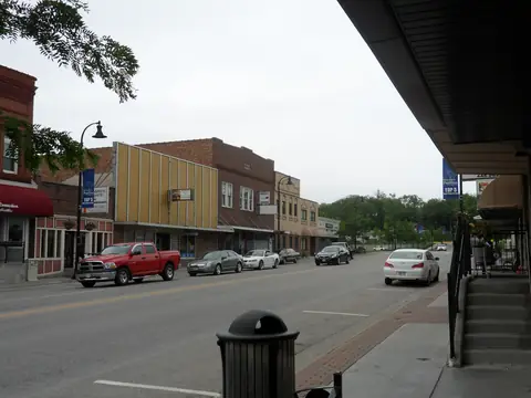 Shops and parked cars along the main street of downtown Papillion, Nebraska