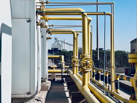 Yellow pipelines and valves at an industrial plant on a sunny day