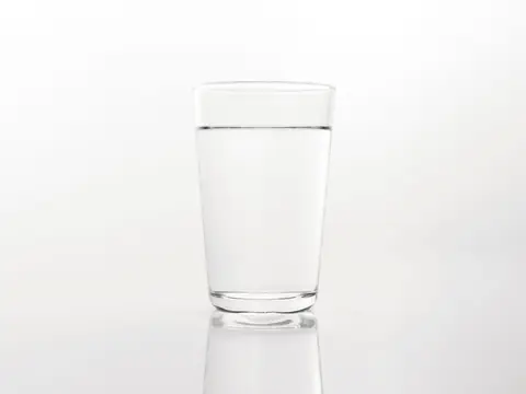 A clear glass of water on a white surface